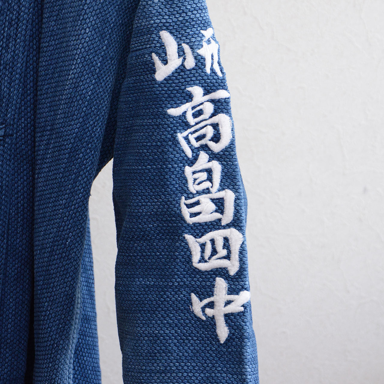 Blue indigo cotton jacket with detailed sashiko stitching and sleeve design