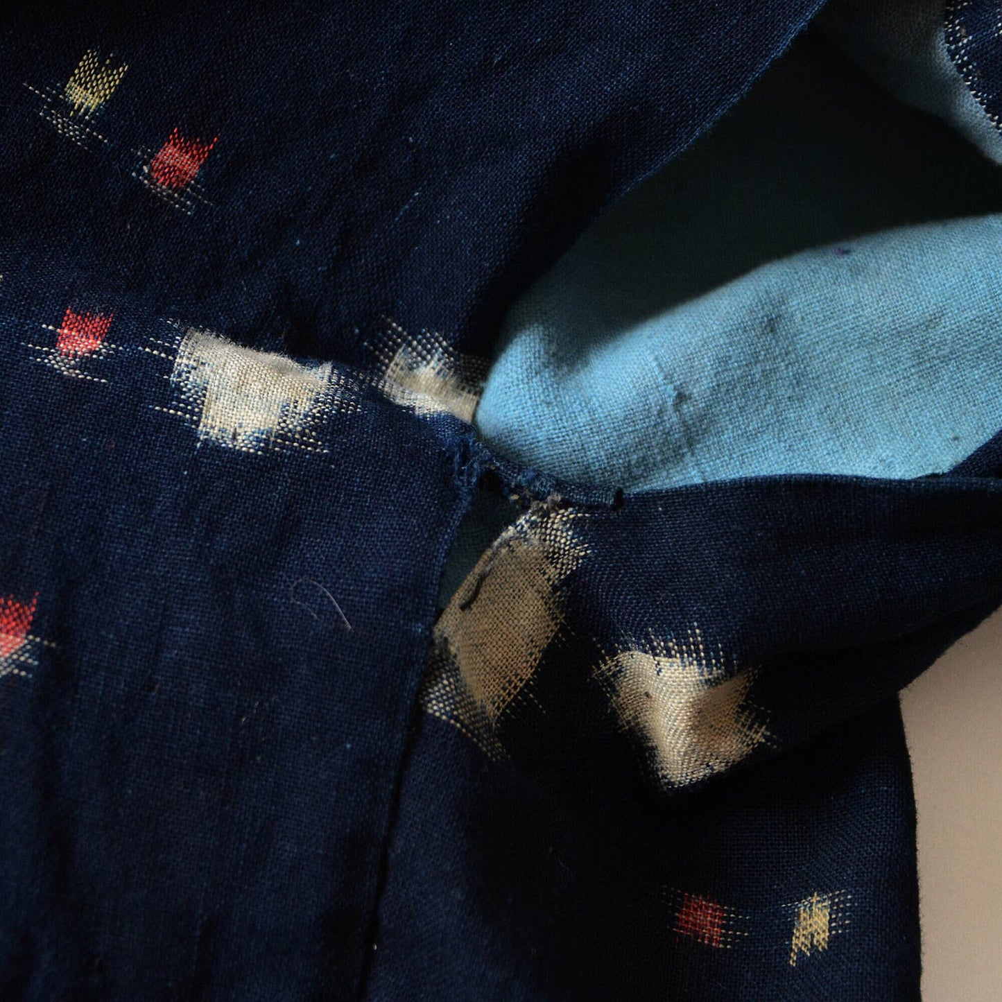 Close-up of the underarm hole and side vent (miyatsuguchi) on a noragi, showcasing its traditional wear and design