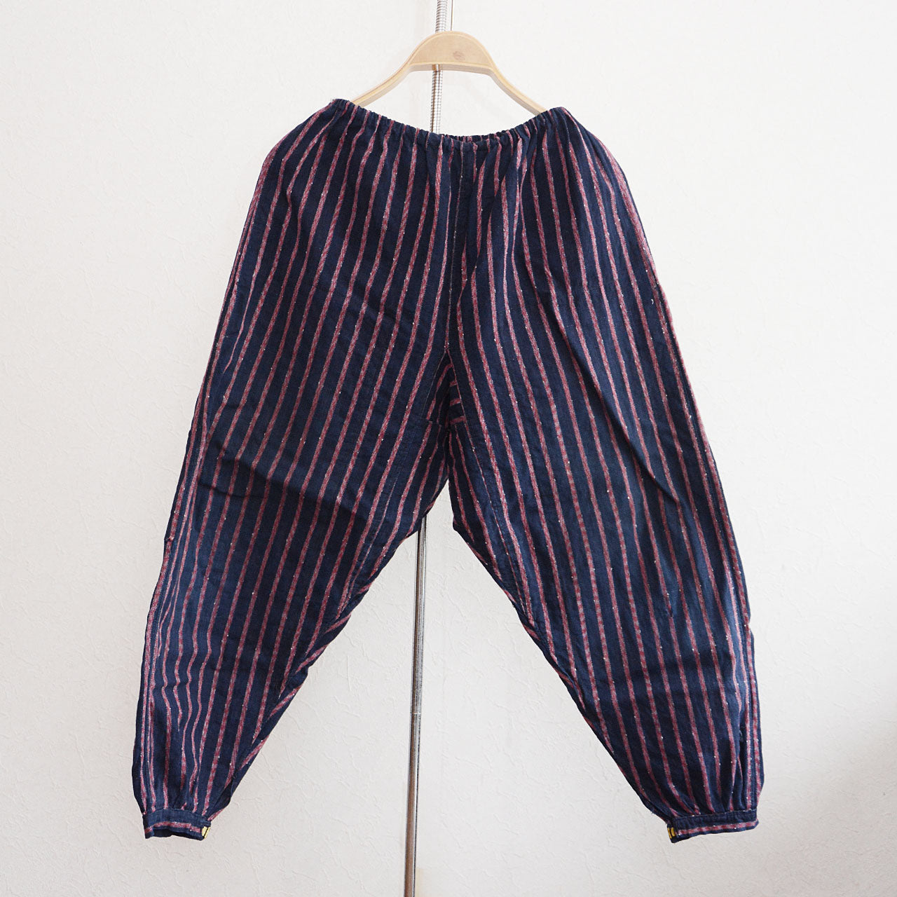 Vintage Japanese monpe pants in indigo-dyed striped cotton with metal ankle clasps