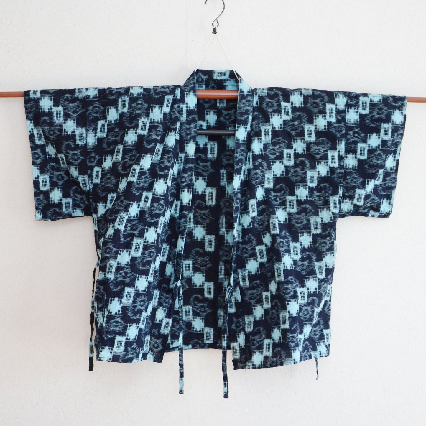Front view of the vintage indigo-dyed Noragi jacket laid flat.