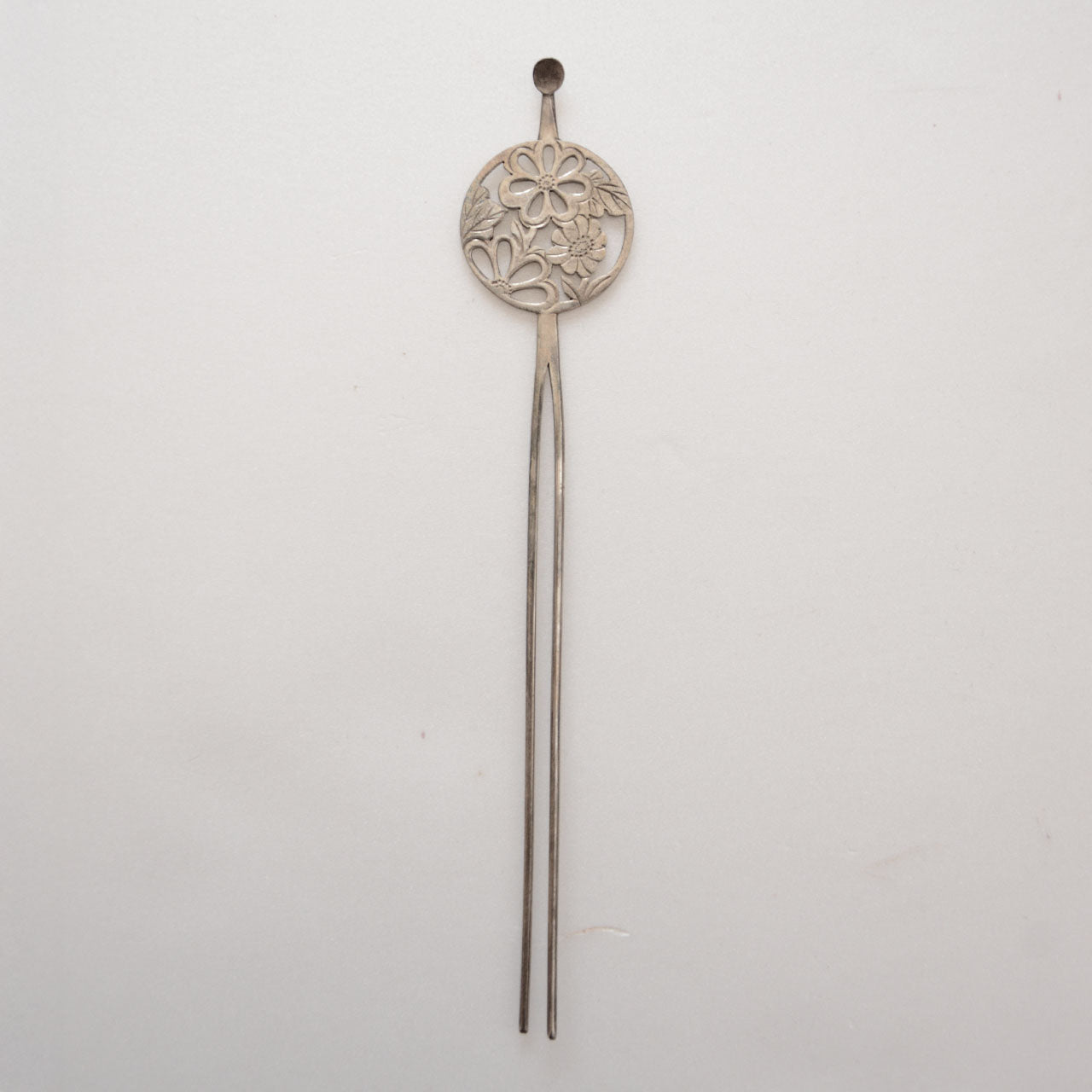 Two-pronged antique kanzashi hair accessory in silver tone with traditional flower motif