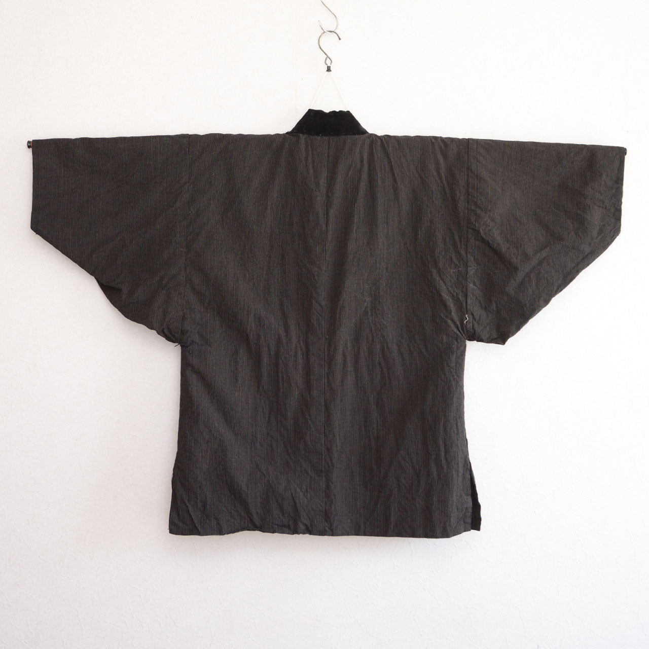 traditional japanese jacket with curved sleeves and indigo stripes