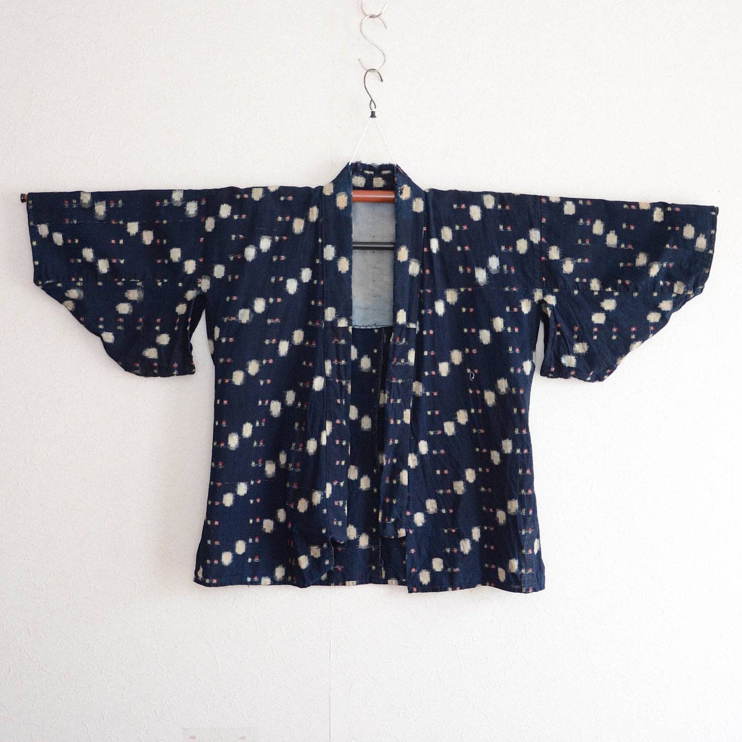 Vintage noragi displayed on a kimono hanger, front view