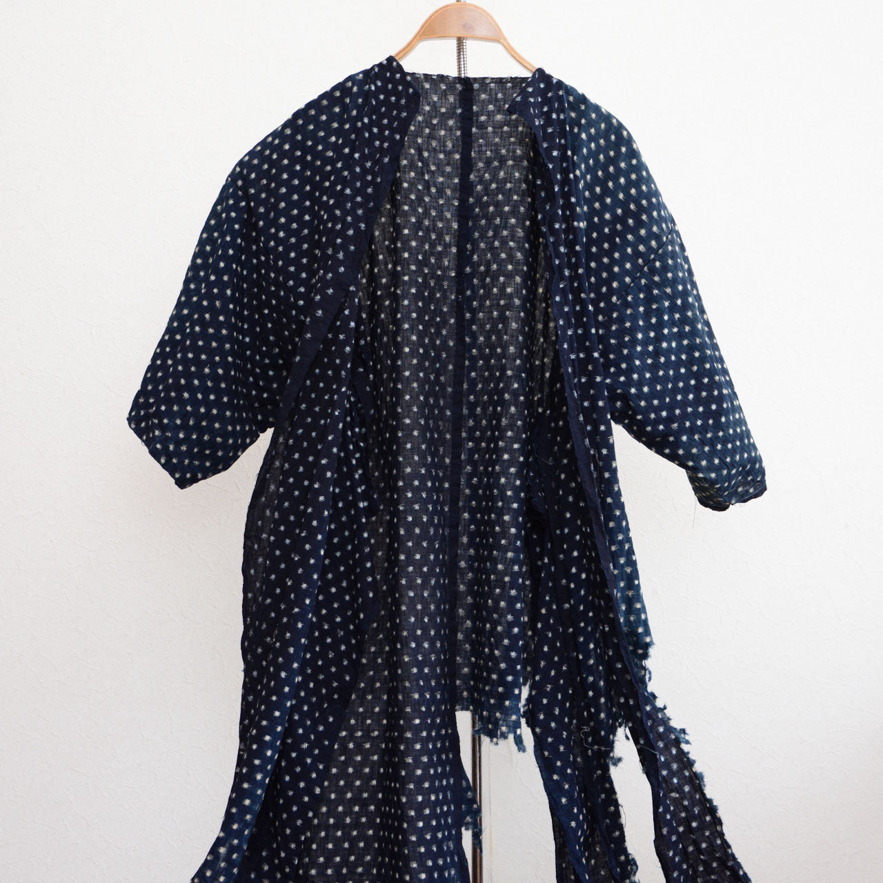 Worn vintage kimono featuring snowflake-style kasuri design