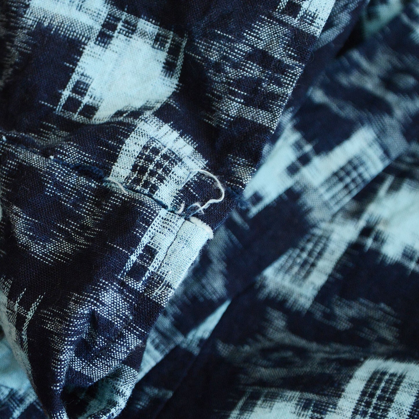 Bottom hem detail with natural fading and fraying.