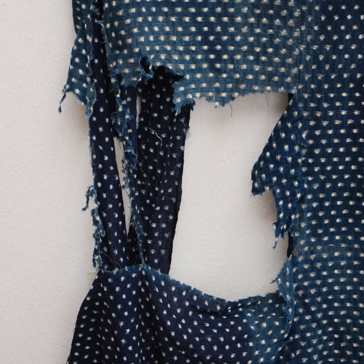 Old Japanese boro fabric with frayed edges and patched sections