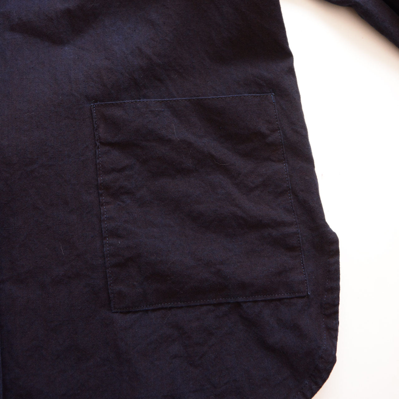 Indigo-dyed cotton band collar jacket with minimalist Japanese design