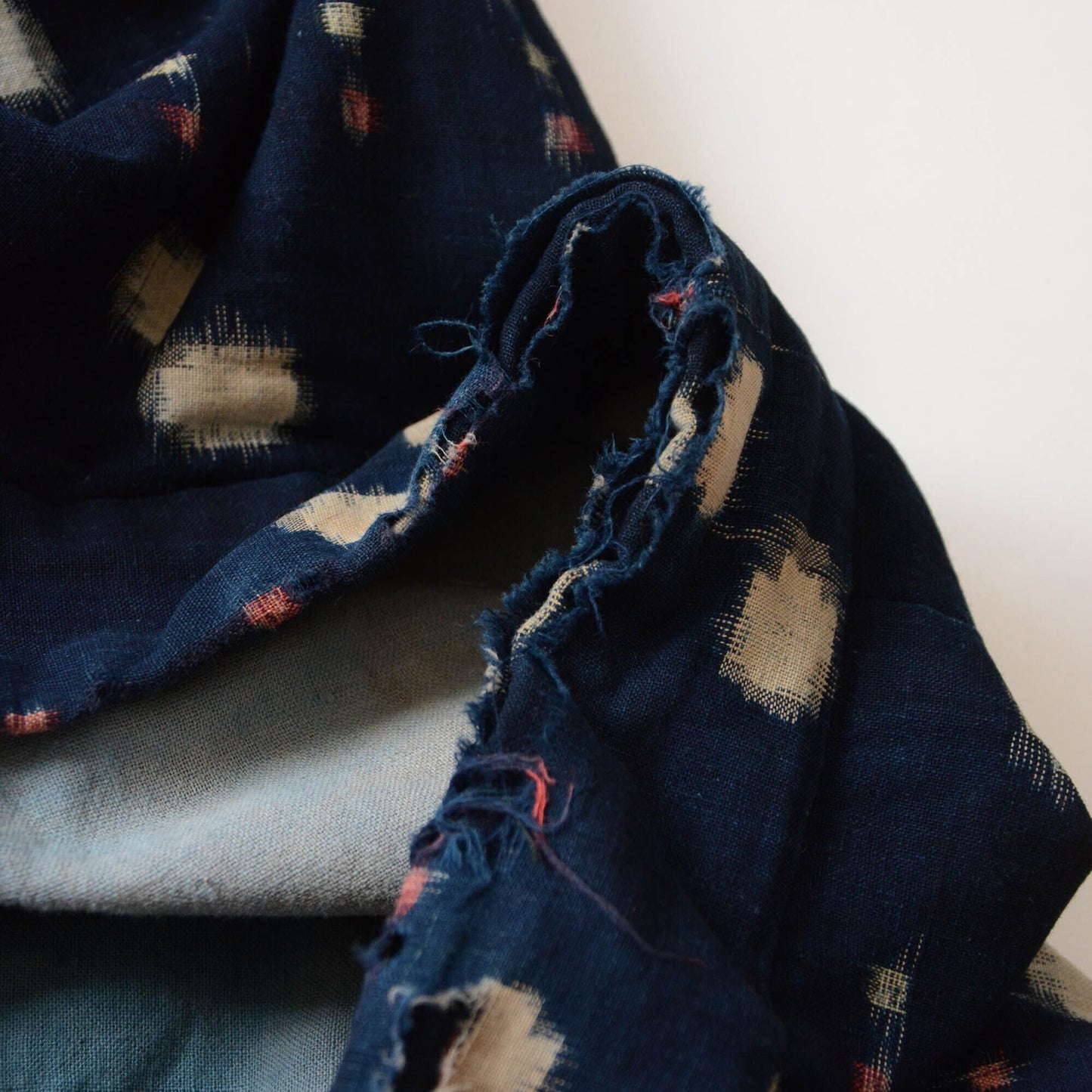Close-up of the damaged collar of a vintage noragi, showcasing its unique wear and beauty