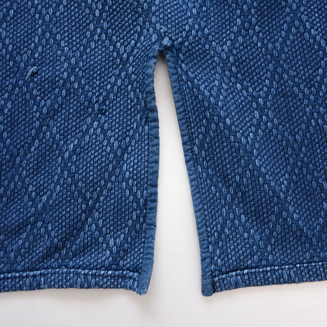 Thick indigo sashiko cotton fabric with visible texture and embroidery