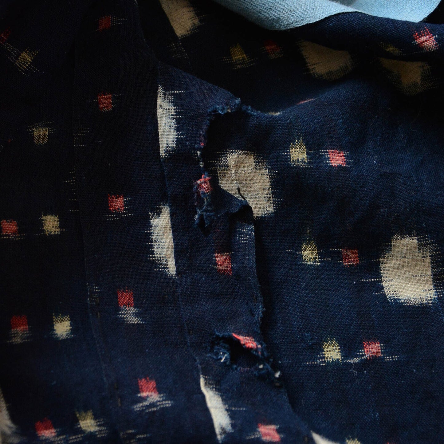 Close-up of the dot-patterned kasuri fabric, highlighting its intricate weave and texture