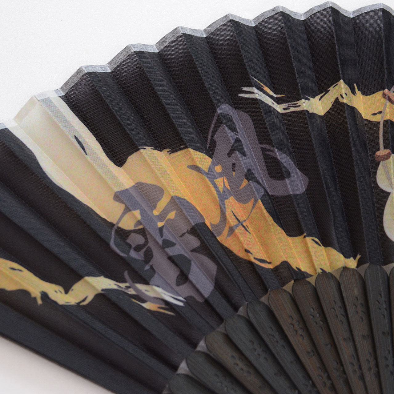 Folded Japanese fan with traditional artwork
