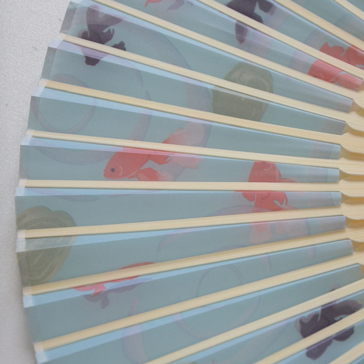 Handheld fan for festivals with classic goldfish imagery