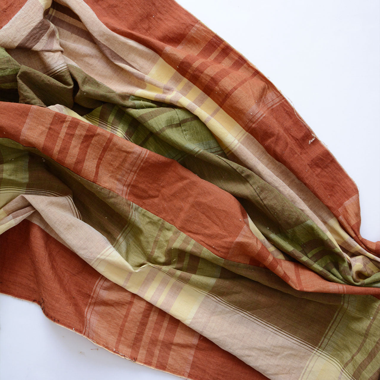 Japanese vintage cotton fabric, multicolor plaid in rust red, olive green, and cream, unstitched Showa-era futon textile, full drape showing both colorways layered together