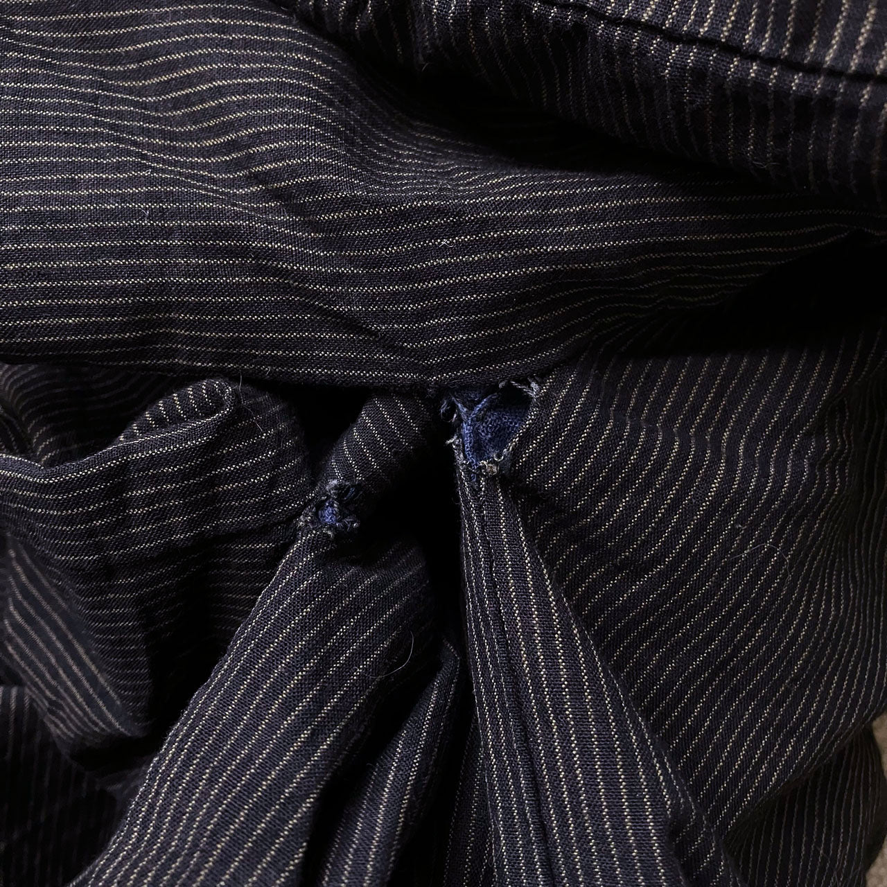 Underarm detail — loosened stitching on dark cotton stripe fabric, early Showa era Japan vintage men's kimono