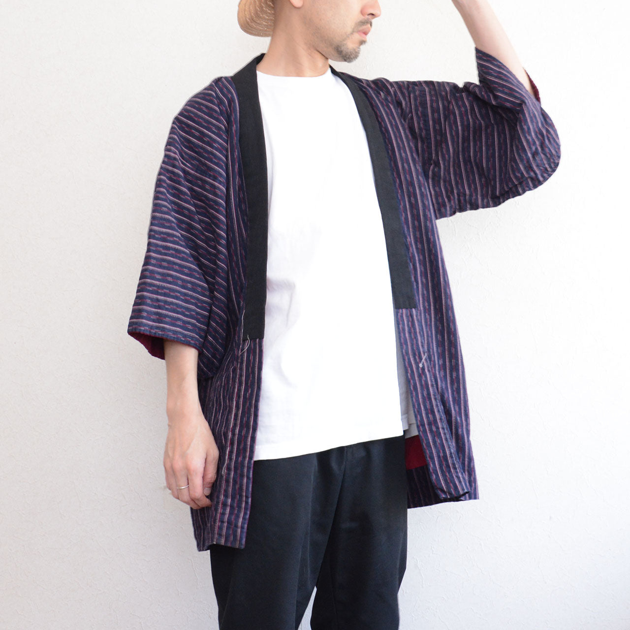 Navy cotton stripe noragi jacket worn, front view, styled over white tee and black trousers
