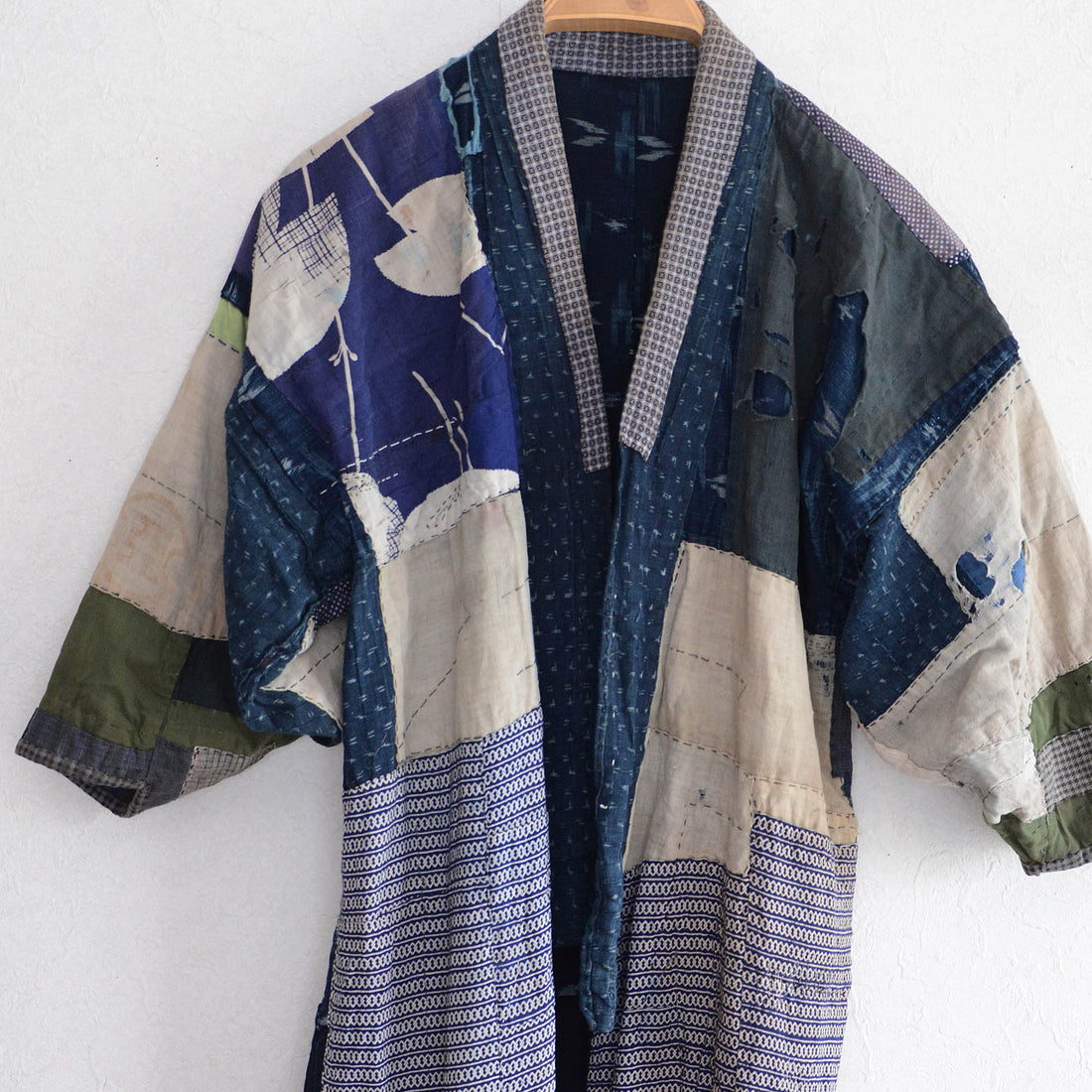 Vintage Japanese boro noragi jacket with crazy patchwork — indigo kasuri, shibori, and mixed cotton fabrics, Showa era
