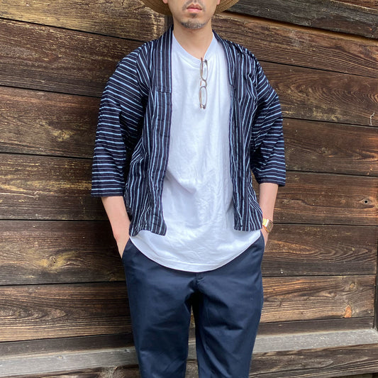 Man wearing an indigo-dyed vintage Japanese noragi jacket paired with a casual white T-shirt