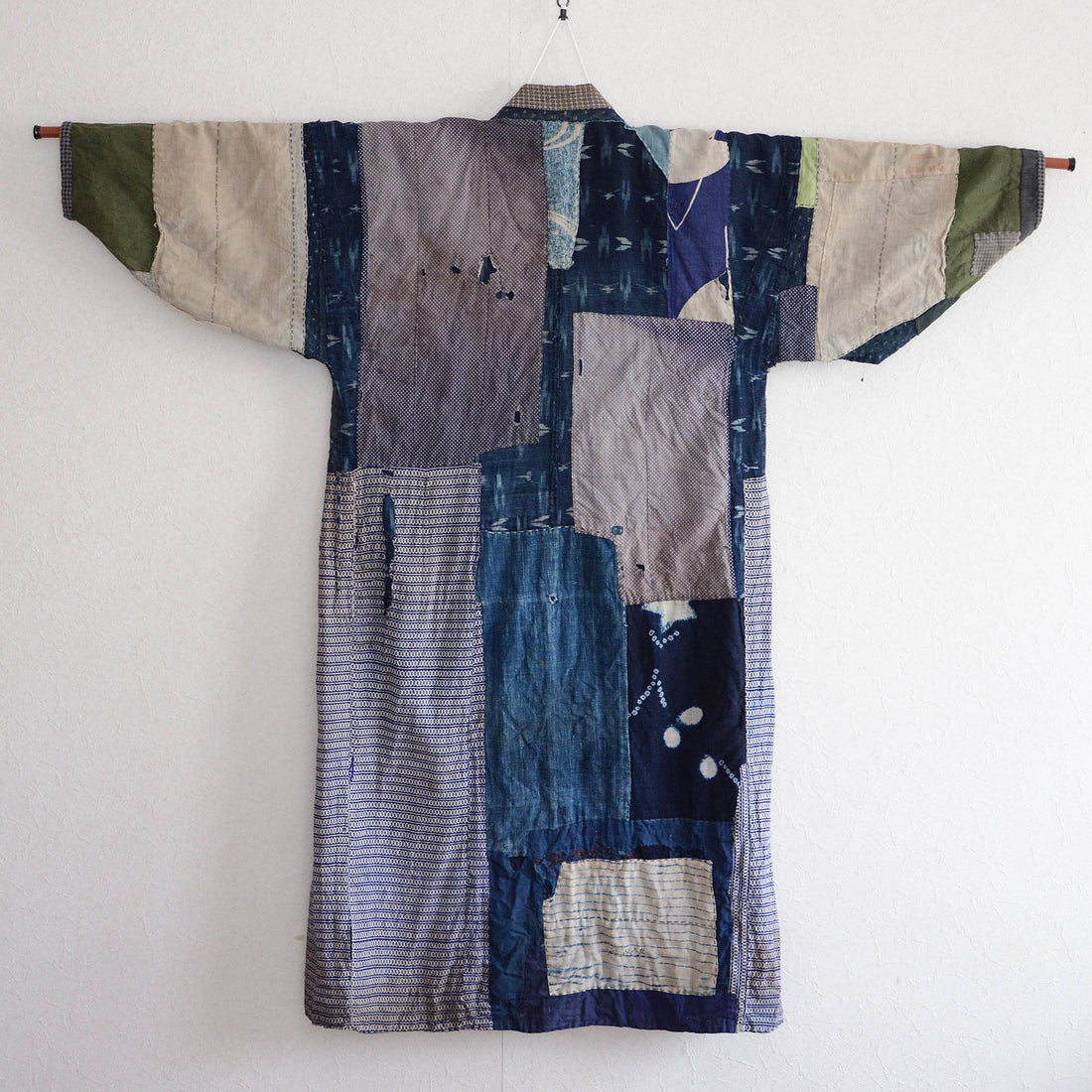 Vintage Japanese boro noragi jacket with crazy patchwork — indigo kasuri, shibori, and mixed cotton fabrics, Showa era