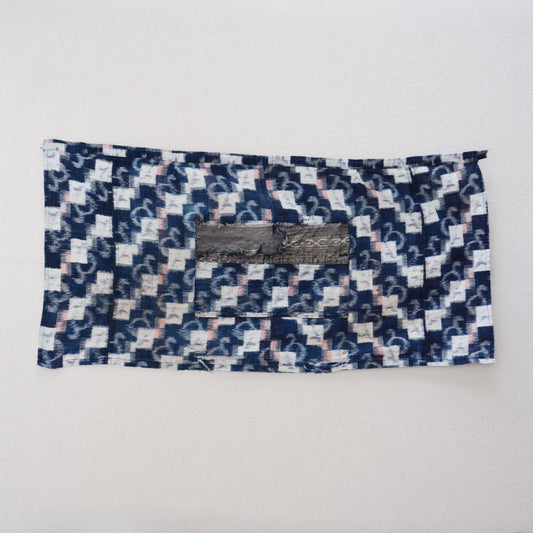Mid-Showa Japanese vintage indigo cotton fabric with white angular and curved kasuri motifs, red accents and a remaining central pocket