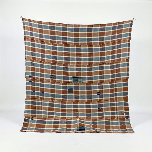 Japanese vintage boro fabric in brown, blue-gray, and cream checkered cotton with visible repair patches