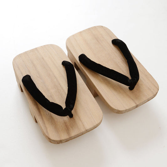 Aizu Paulownia wood geta sandals with two teeth (nimaiba) and black fabric hanao thong straps, unfinished natural wood surface