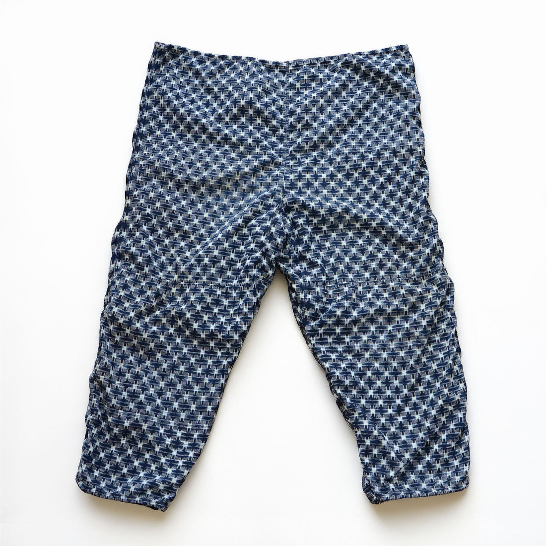 Indigo kasuri cotton monpe pants, front view, navy and white ikat check pattern, Showa era Japanese vintage workwear