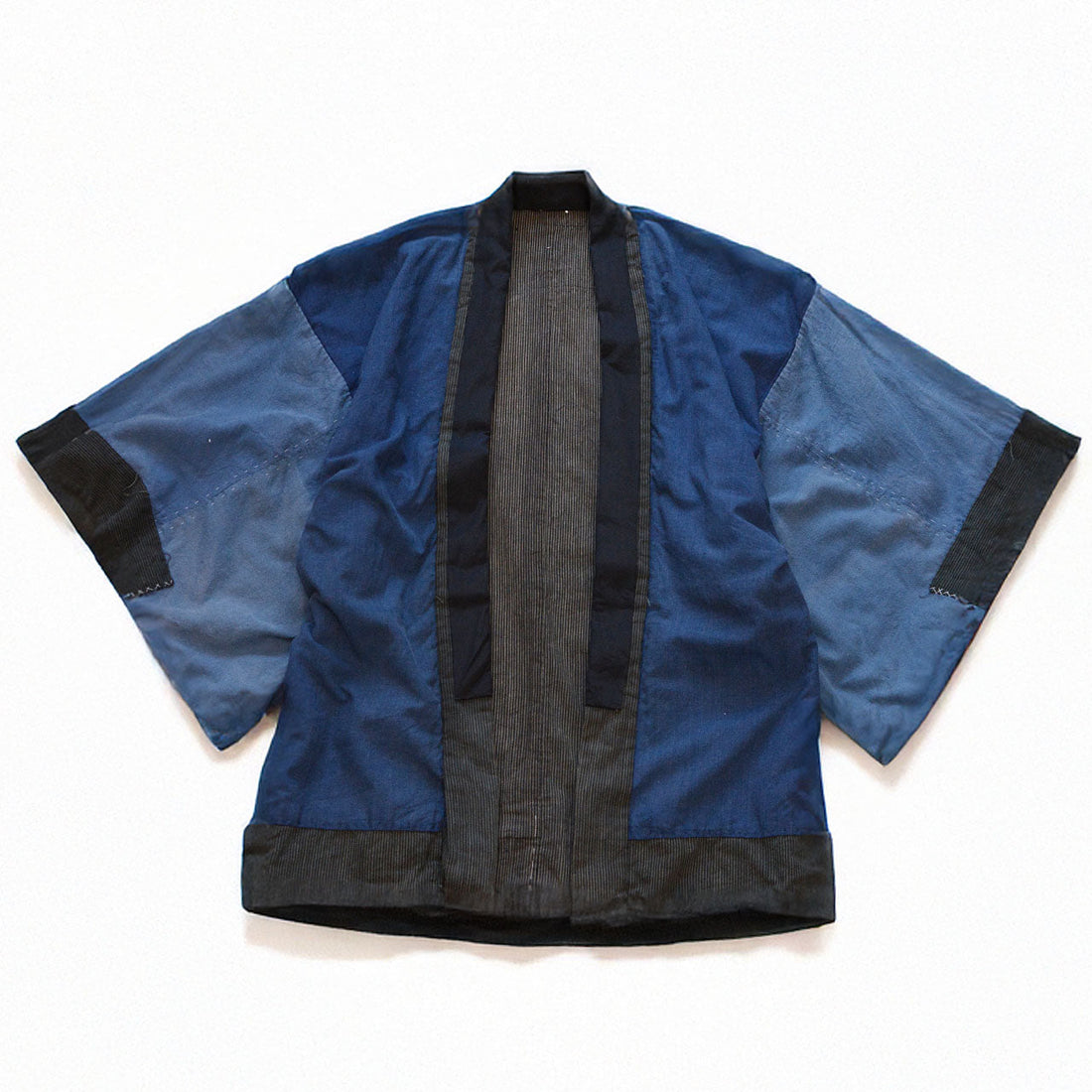 Early Showa era boro noragi jacket, reverse side front view, indigo-dyed cotton body with crazy pattern sleeves, laid flat