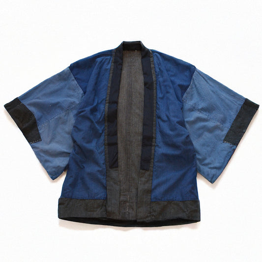 Early Showa era boro noragi jacket, reverse side front view, indigo-dyed cotton body with crazy pattern sleeves, laid flat