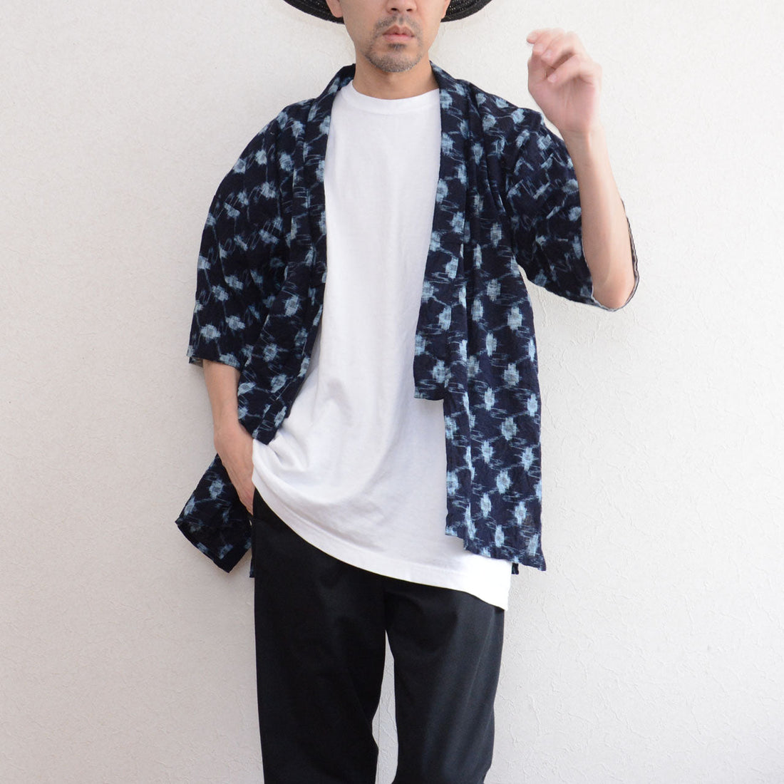 Indigo kasuri noragi jacket worn open over white tee and black trousers, men, straw hat, Showa era Japan vintage
