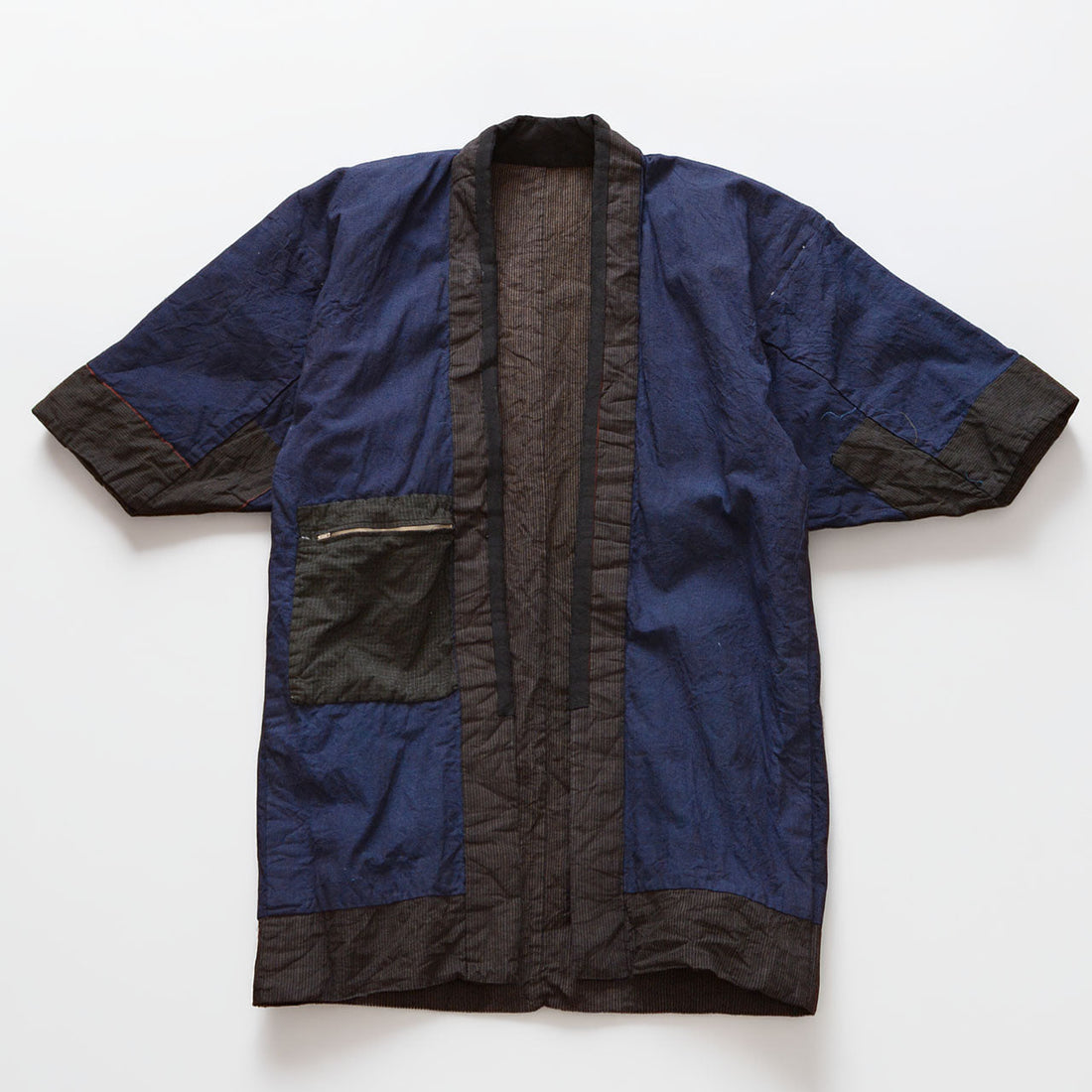 Vintage Japanese noragi work jacket, striped cotton exterior with indigo plain lining, mid-Showa era Tohoku — reverse side, laid flat