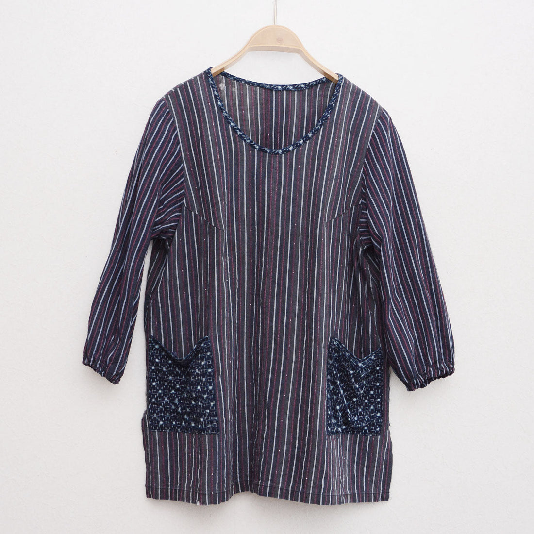 Vintage Japanese remake tunic on hanger, Showa-era stripe cotton with indigo kasuri pockets, front view