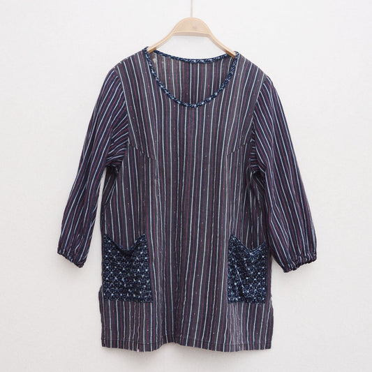 Vintage Japanese remake tunic on hanger, Showa-era stripe cotton with indigo kasuri pockets, front view