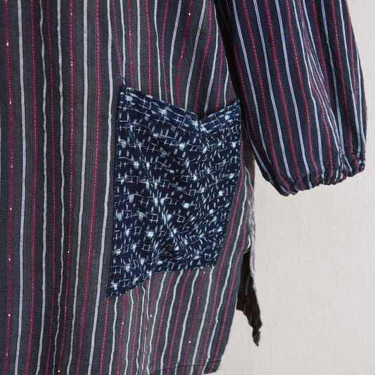 Indigo kasuri pocket close-up on Showa-era stripe cotton tunic, hand-stitched vintage Japanese fabric