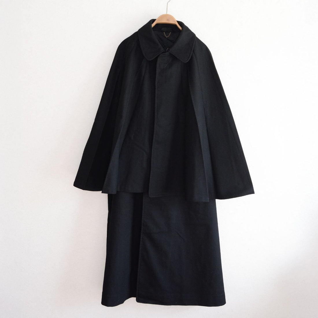 Black wool tonbi mantle coat, front view on hanger, double-cape Inverness silhouette, Taisho–Early Showa Japan vintage