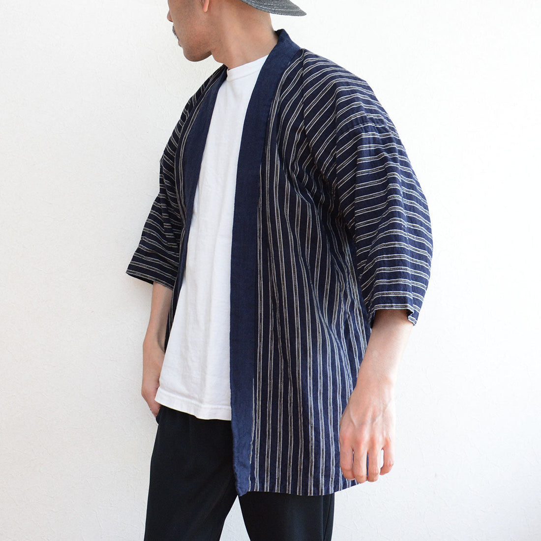 Man wearing vintage noragi jacket over white t-shirt, indigo-dyed collar striped cotton, Showa era Japan vintage, styled for summer