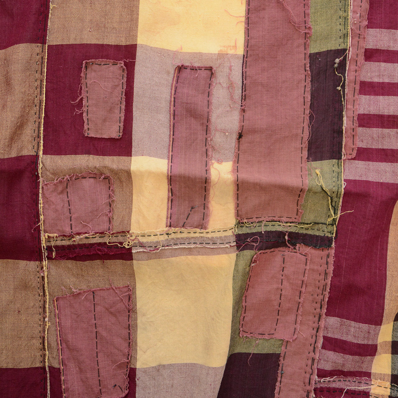 Heavily repaired Japanese futon cover showing signs of long use