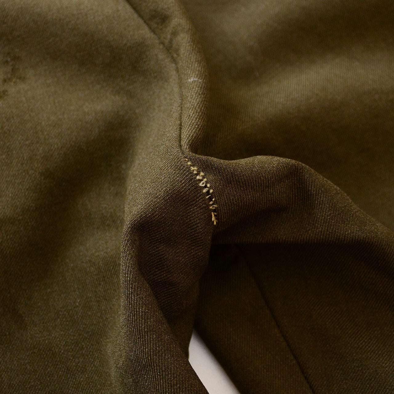 Worn vintage wool trousers showing historical wear and tear