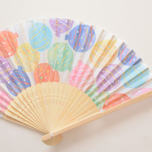 Folding fan with colorful water balloon pattern