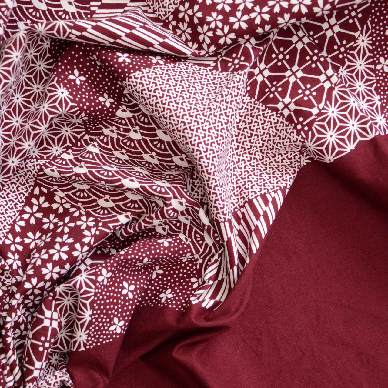 Vintage Japanese furoshiki with traditional patterns in burgundy and white