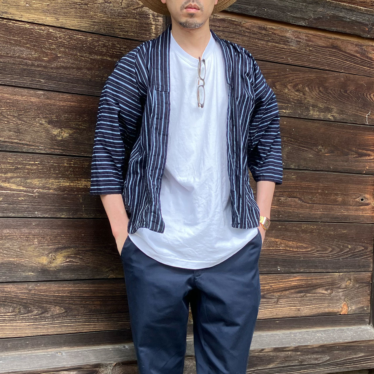 Man wearing an indigo-dyed vintage Japanese noragi jacket paired with a casual white T-shirt, showcasing a blend of traditional workwear and modern style.