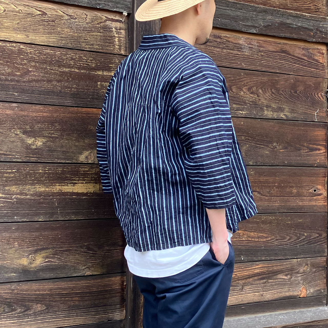 Back view of a man wearing a vintage Japanese noragi jacket, showcasing the overall fit and design from behind.
