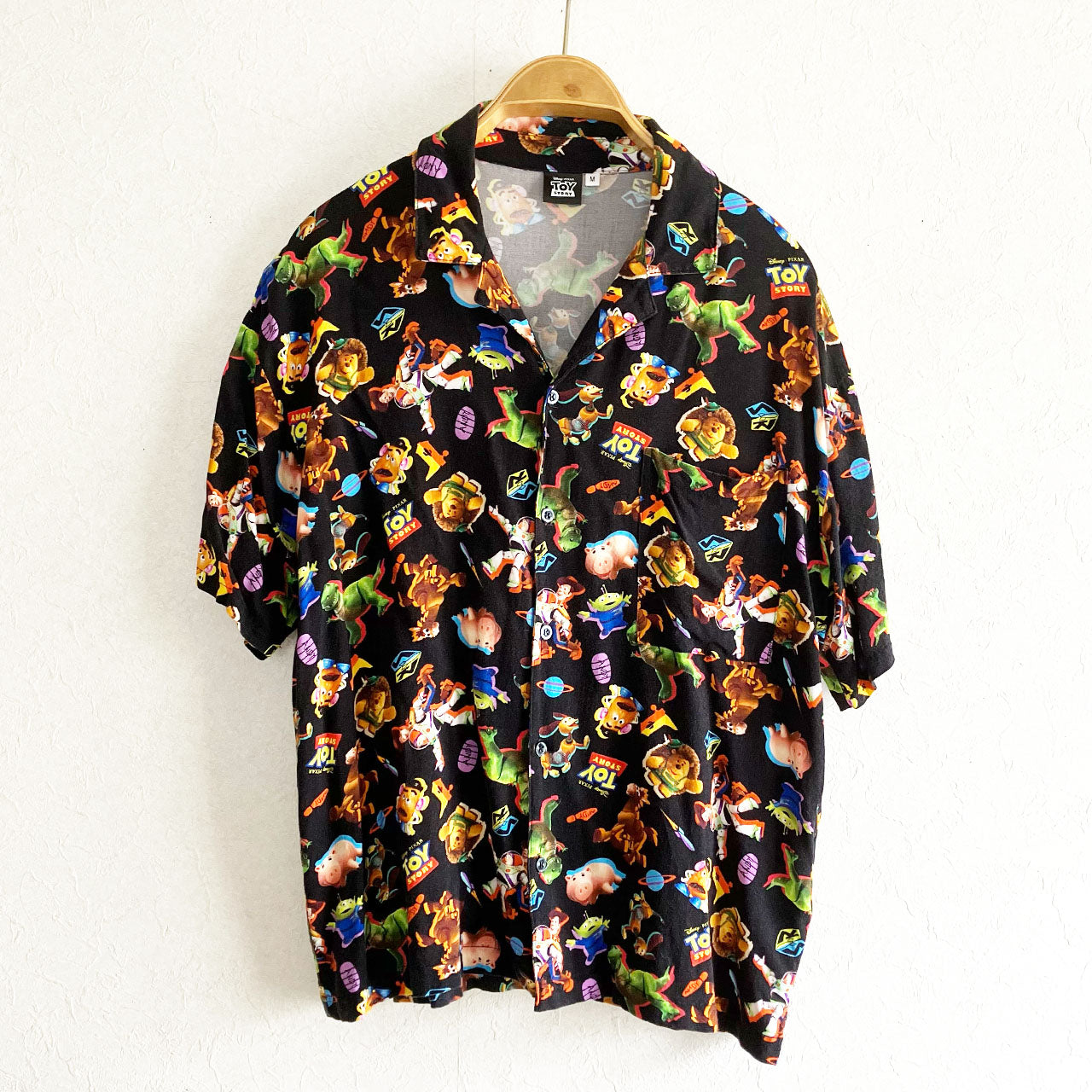Black rayon Hawaiian shirt featuring Toy Story all over print with Woody and Mr. Potato Head, mens size M