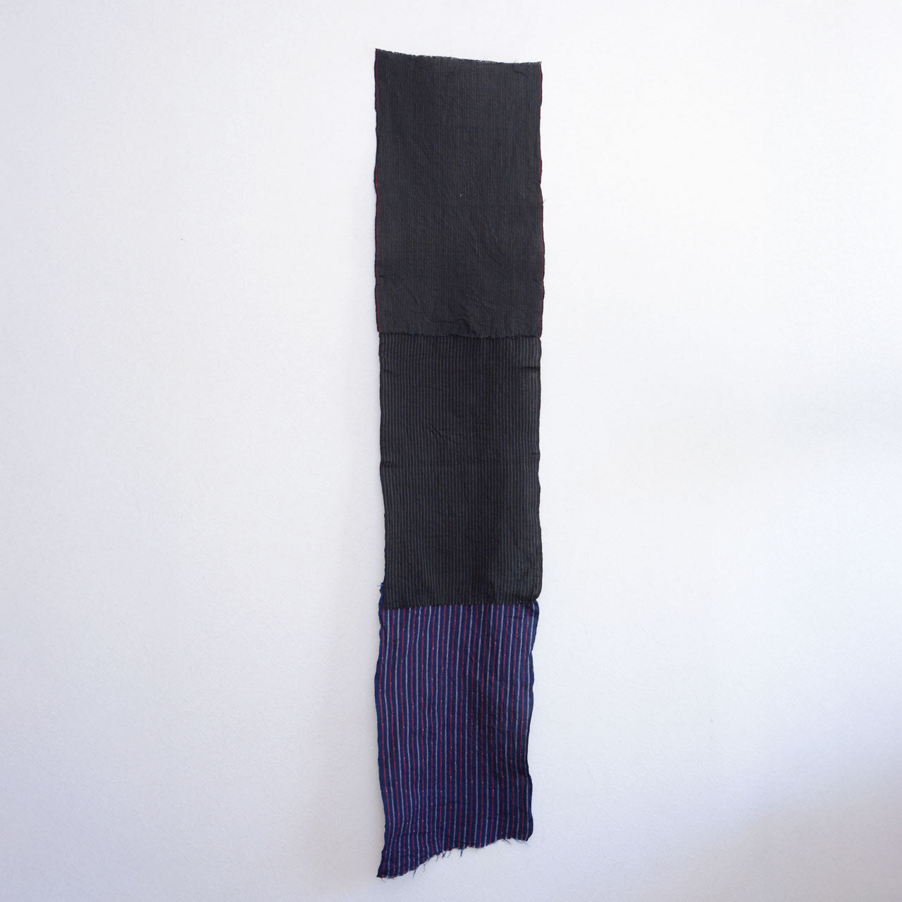 Hand-sewn patchwork fabric with striped cotton textures