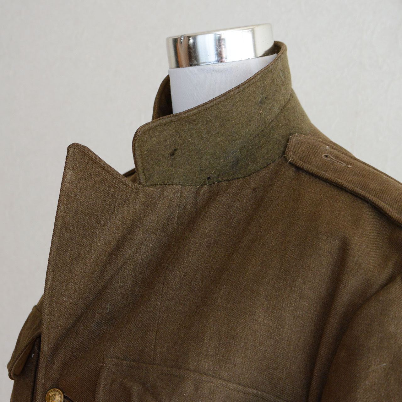A 1940s military officer jacket with modified closure construction.