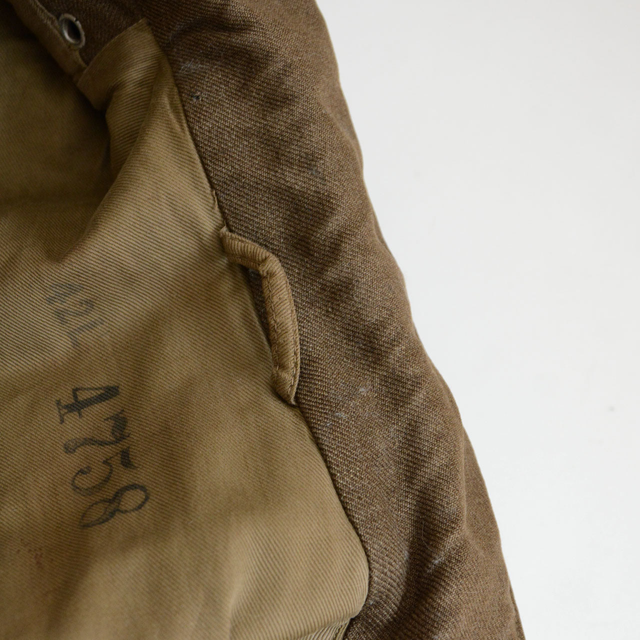 A 1940s officer jacket reflecting postwar clothing shortage adaptation.