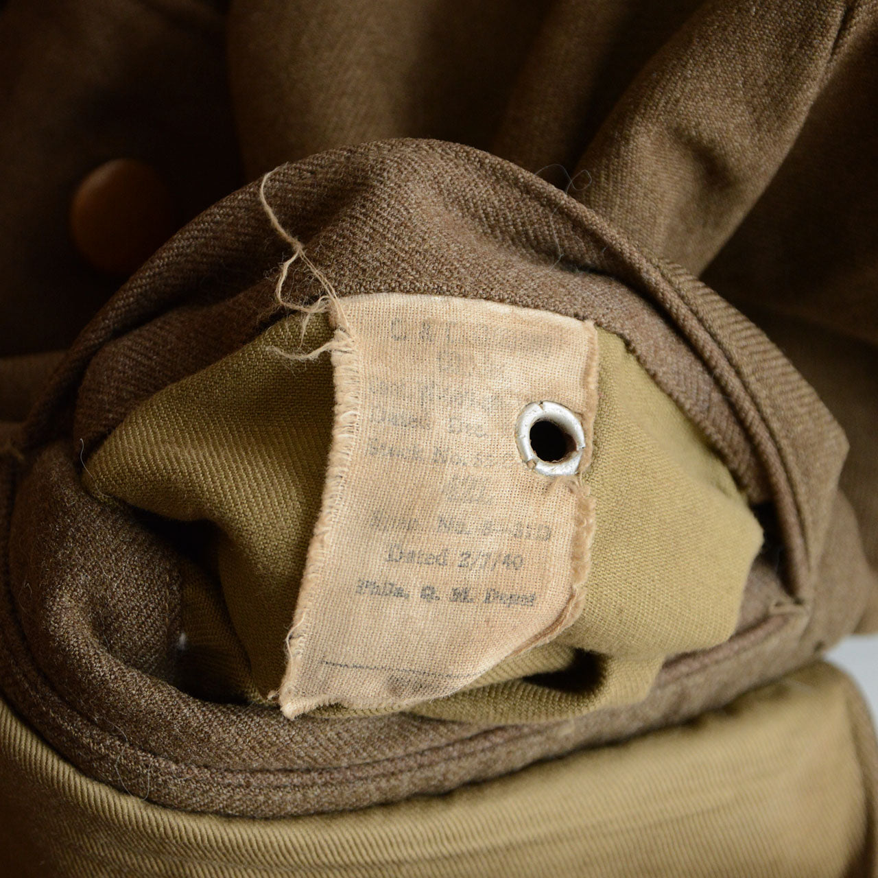 A 1940s military officer jacket with visible postwar structural changes.