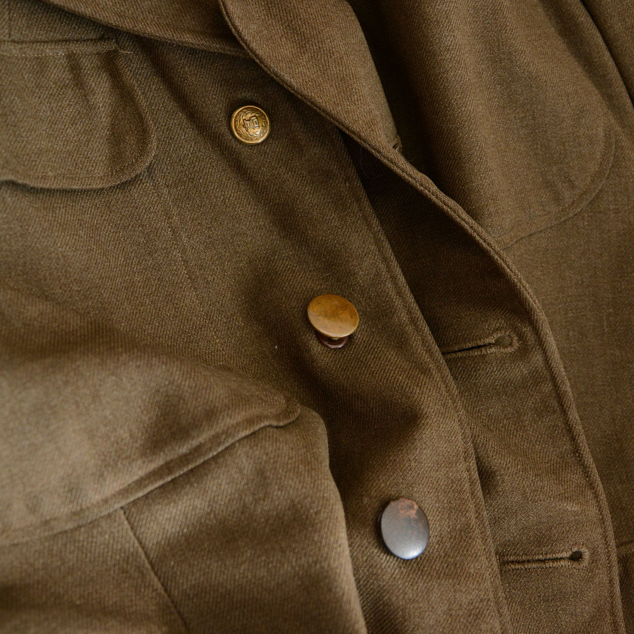 A vintage U.S. Army officer jacket with layered postwar modifications.