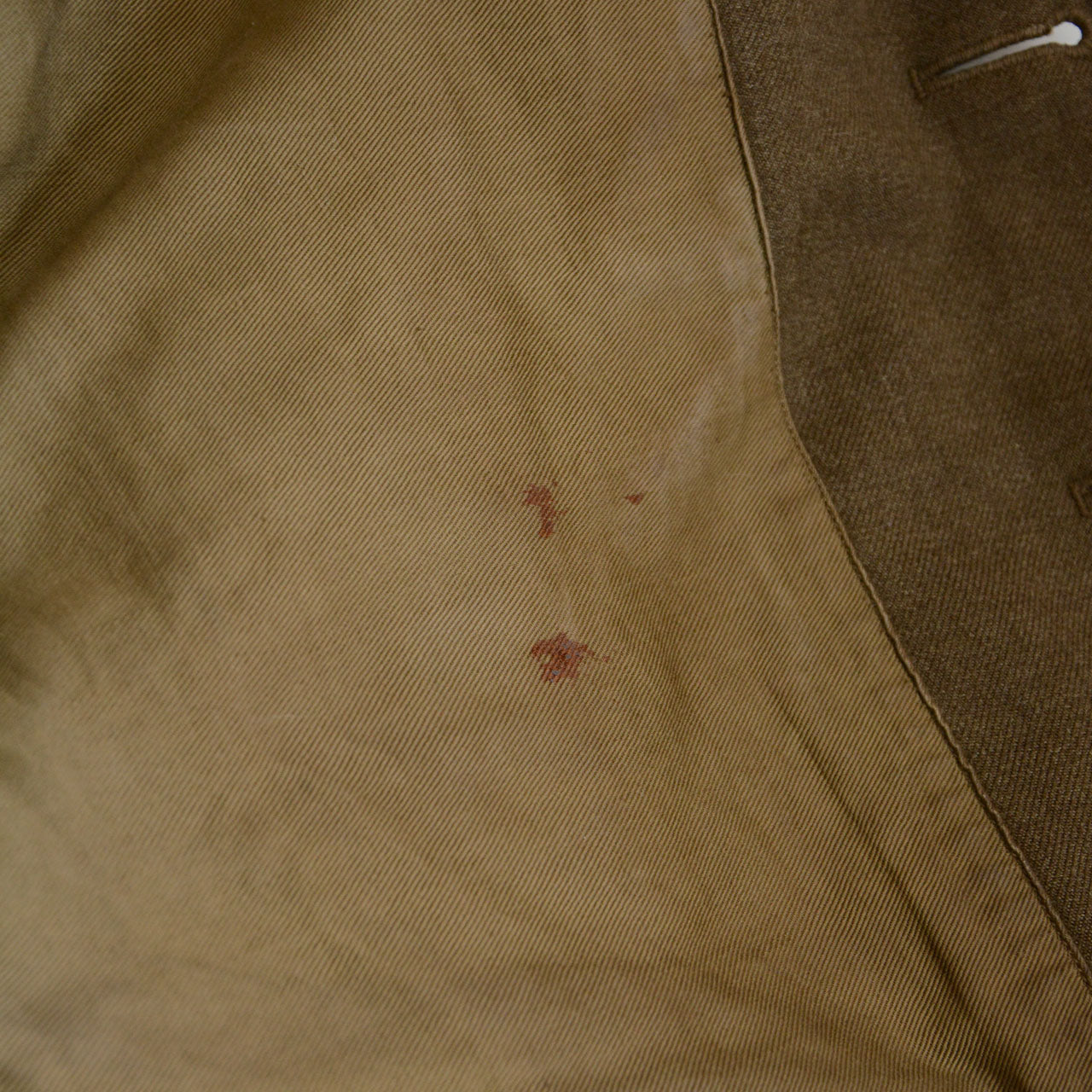 A U.S. Army officer jacket modified with a cord-tied button system.