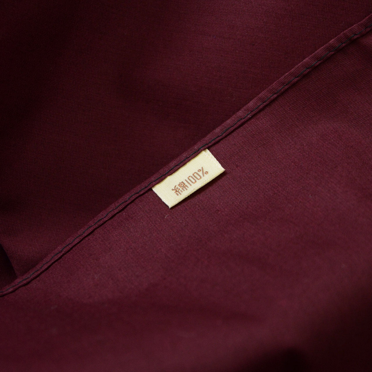 Burgundy vintage cotton textile with symmetrical white motif design