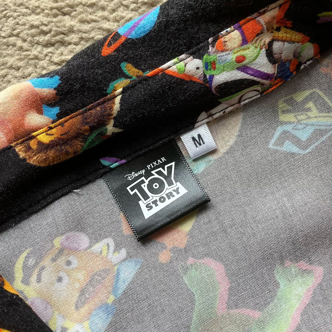 Toy Story themed aloha shirt in black, all over print design, rayon fabric, good pre-owned condition, size M